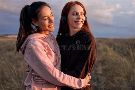 Positive Caucasian Women Posing At Camera Having Rest After Jogging On Field Stock Image