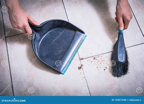 Cleaning Dust On Tile Floor With Brush And Dustpan Holded By Female