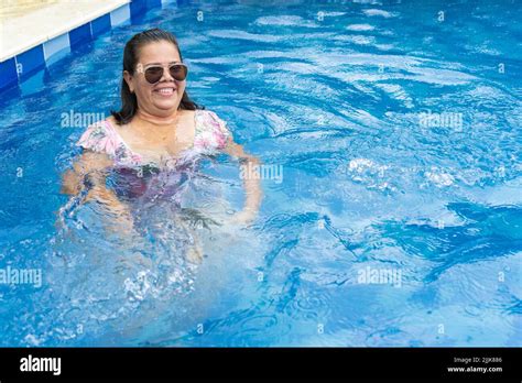 Senior Woman Relaxing In Swimming Pool Stock Photo Alamy
