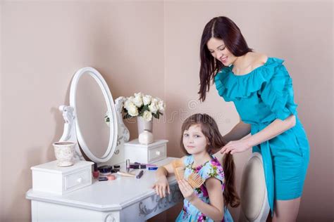 Mother Hairdressing Her Preteen Beautiful Daughter At Home Stock Image