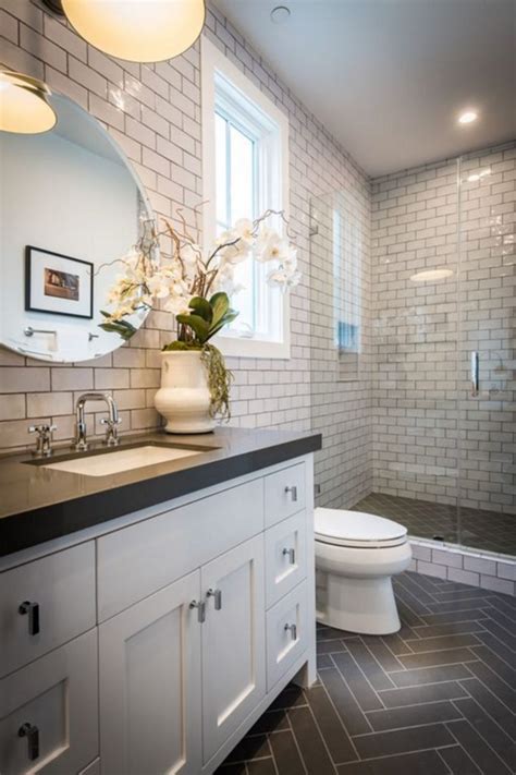 Bathrooms with black herringbone floor tiles and white subway tile with black grout, plus wood sitting bench via inside out | black and white bathrooms #whitetiledbathroom. 25+ Awesome Bathroom Tile Ideas For Beautiful Home ...