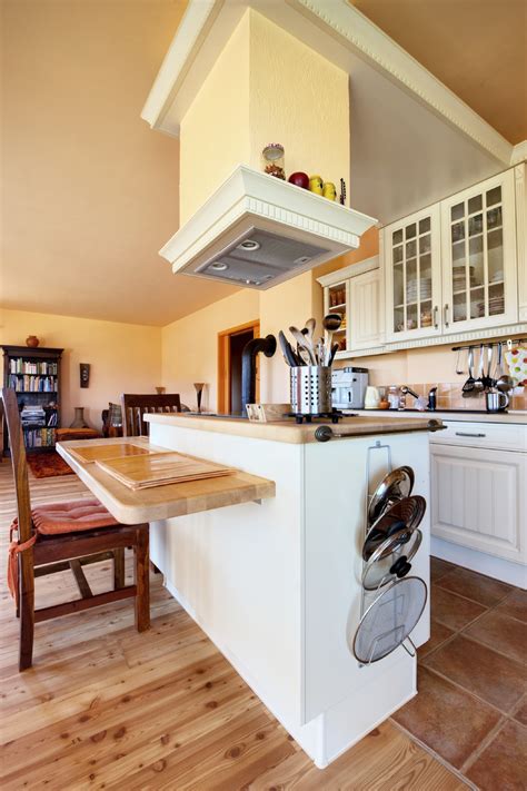 Cabinetry explains the allure and function of the kitchen. Stylish Kitchen with Two Tier Kitchen Island - HomesFeed