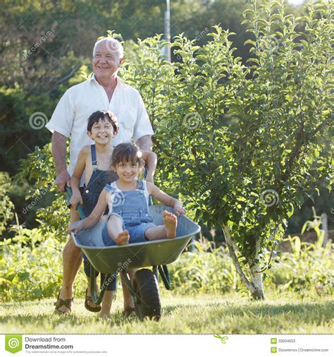 Grandfather Rolls The Children Stock Image Image Of Child Gardener