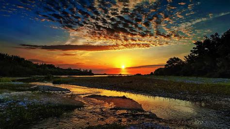 Gorgeous Sunset Over A Meandering River Rocks Sunset River Clouds