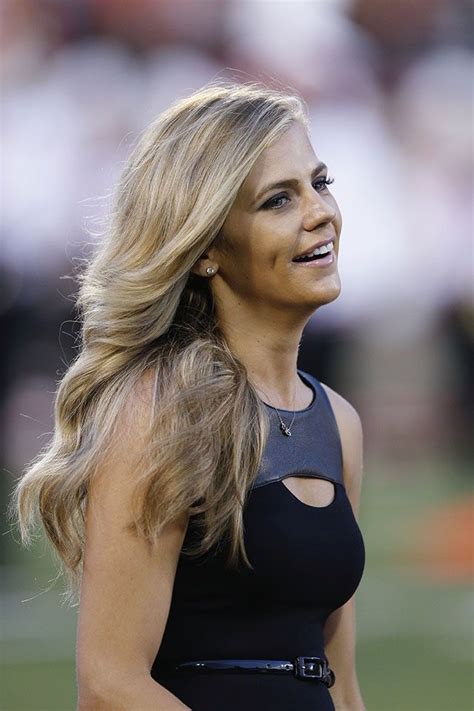 A Woman With Long Blonde Hair Wearing A Black Dress And Looking Off