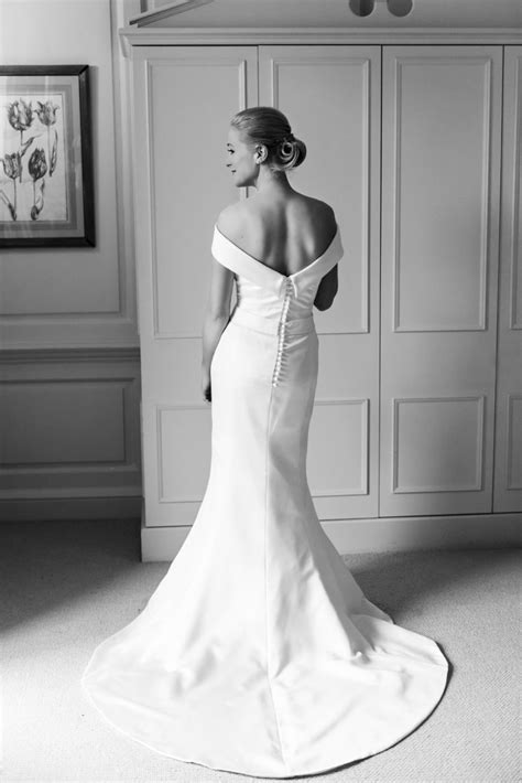 Black And White Photo Of Woman In Wedding Dress Looking Off To The Side