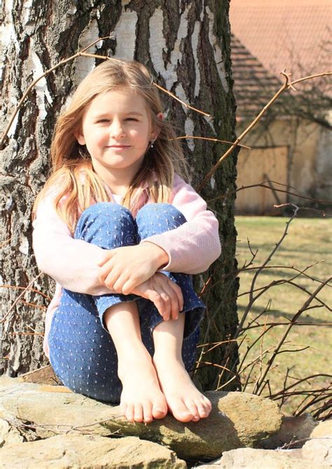 Barefoot Girl Sitting Outside