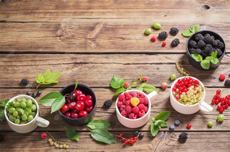 Premium Photo Different Berries On Old Wooden Background