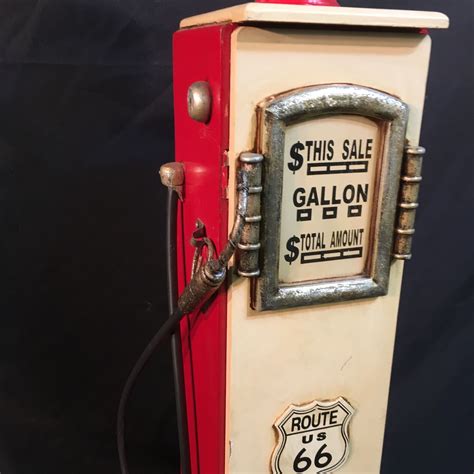 It is shaped like a gas pump. VINTAGE ROUTE 66 GAS PUMP SHAPED WOODEN CABINET, 35'' TALL