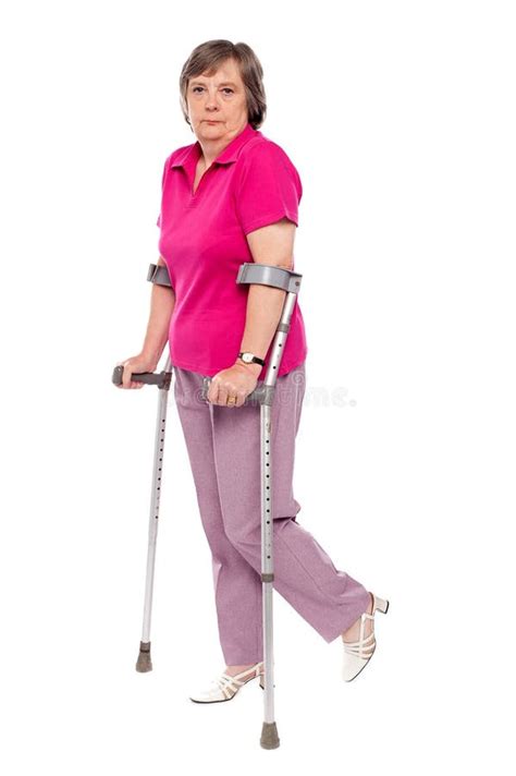 Unhappy Handicapped Woman With Crutches Royalty Free Stock Photo