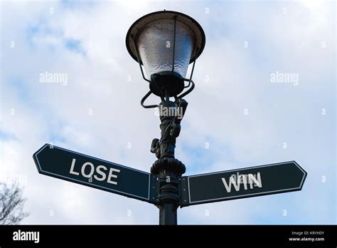 Lose Versus Win Directional Signs On Guidepost Stock Photo Alamy