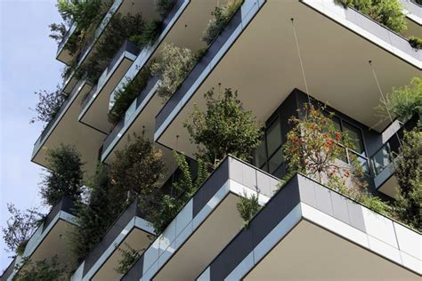 An Apartment Building With Plants Growing On The Balconies