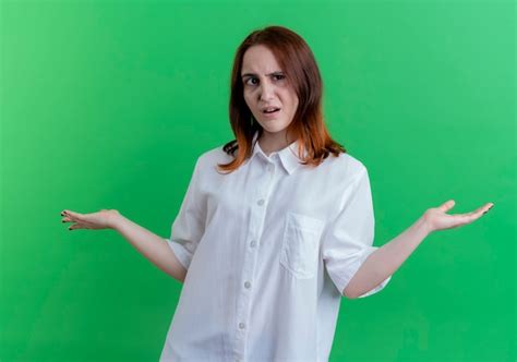 Free Photo Confused Young Redhead Girl Spreads Hands Isolated On