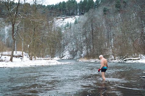 Boy Or Man Walking And Going To Swim In The Cold Water Of A River In A