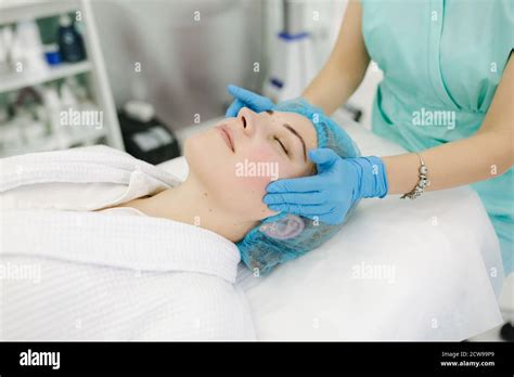 Cosmetoligist Make Facial Massage In Beauty Salon Preparing For Injection Cosmetologist In