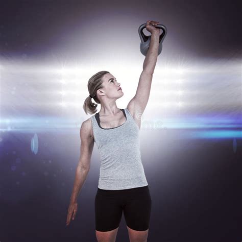 Composite Image Of Serious Muscular Woman Lifting Kettlebell Stock