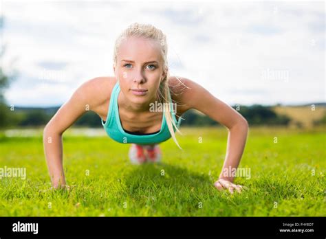 Blonde Woman Doing Push Ups In The Park Stock Photo Alamy