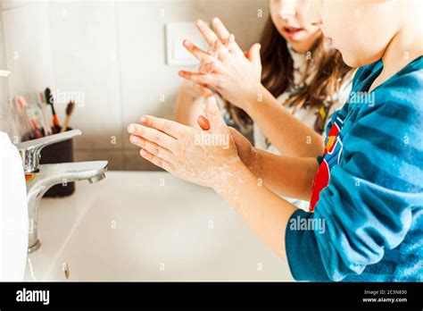Boy And Girl Washing Their Hands With Soap Stock Photo Alamy