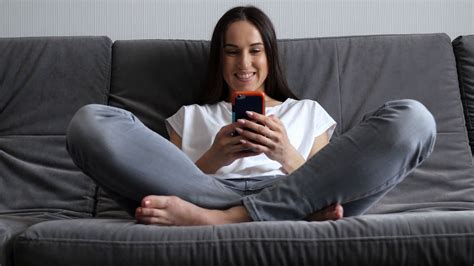 Woman With Crossed Legs Sitting On Sofa With Stock Footage Sbv