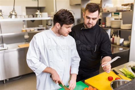 Two Chefs Cooking Food At Restaurant Kitchen Stock Photo Image Of