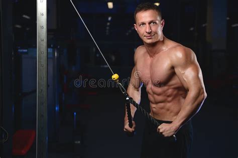 Handsome Athletic Fitness Man Posing And Trains In The Gym Stock Photo