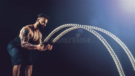 Muscular Man Working Out With Heavy Rope Photo Of Man With Naked Torso Strength And Motivation