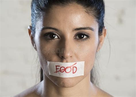 Close Up Face Of Young Beautiful Sad Latin Woman With Mouth Sealed On