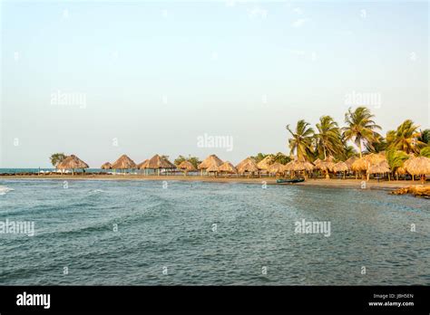 Beach In Covenas Colombia With Palm Trees And Huts Stock Photo Alamy