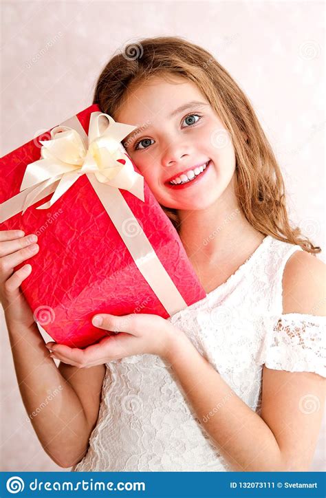 Happy Little Girl Holding Red T Box In Christmas Time Stock Image