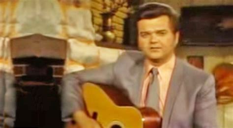Conway Twitty Sits In Front Of Fireplace And Sings Hello Darlin
