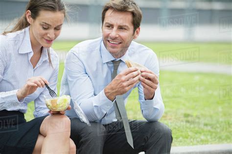 Coworkers Having Lunch Together Outdoors Stock Photo Dissolve