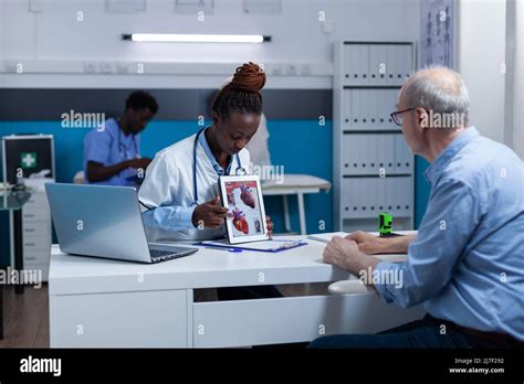 Clinic healthcare cardiology specialist examining senior patient heart