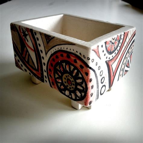 Flat slabs of clay can be fused together to make different objects, such as a box or a house. Ceramic slab boxes