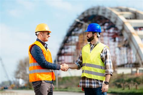 Engineer And Contractor Handshake For Successful Accomplishment Of