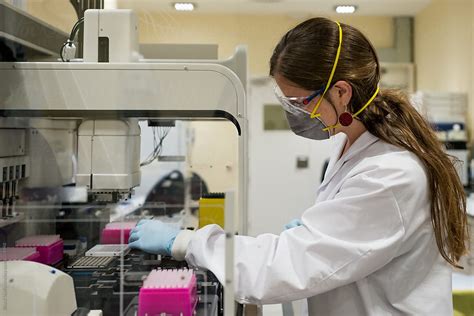 Female Scientist Working With A Genome Sequencing Machine In A Dna