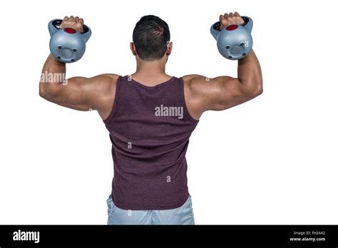 Rear View Of A Muscular Man Lifting Kettlebells Stock Photo Alamy