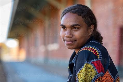 Image Of Head And Shoulders Of Young Aboriginal Woman With Hair Tied