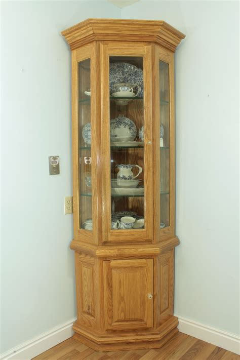 A Wooden China Cabinet With Glass Doors On The Front And Bottom Shelves
