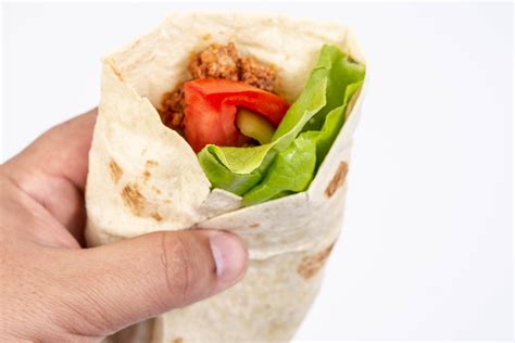 Tortilla With Minced Meat Tomato And Lettuce In The Hand Creative