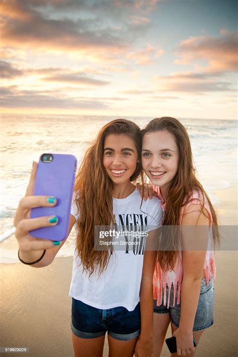 Girlfriends At The Beach Taking Selfies Photos Photo Getty Images