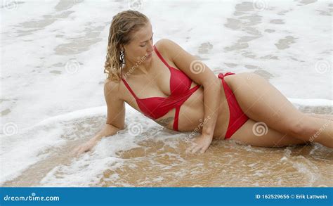 Woman In A Bikini Relaxes On A Sandy Beach At The Ocean Stock Photo Image Of Bikini Beautiful