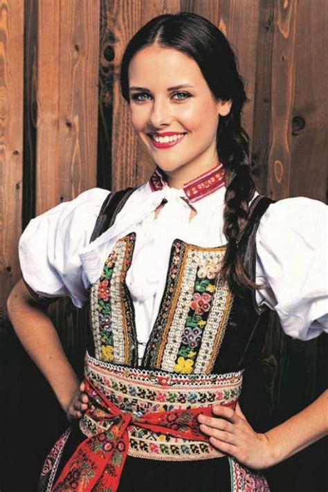 A Woman In A Folk Costume Posing For The Camera With Her Hands On Her Hips