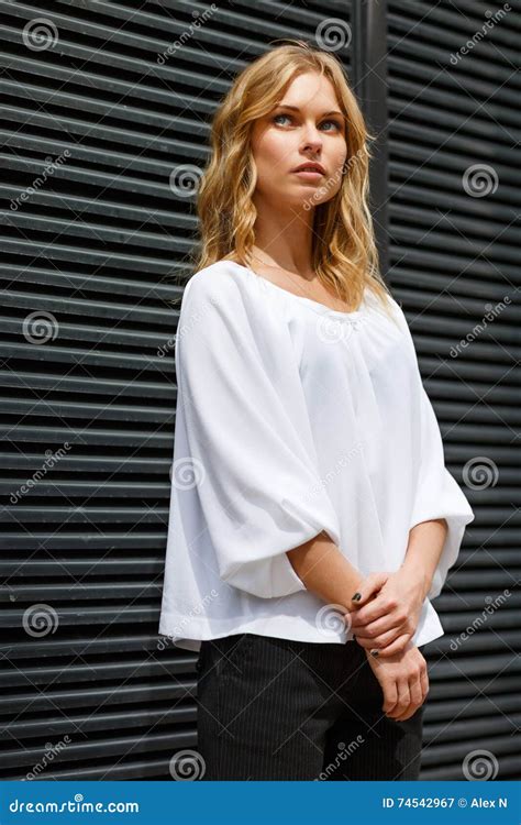 Portrait Of Brooding Blonde Girl In White Blouse Outdors Stock Image
