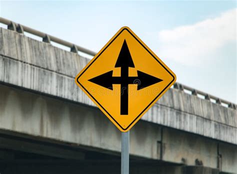Road Sign With Arrows Informs About Crossing On The Road Stock Image