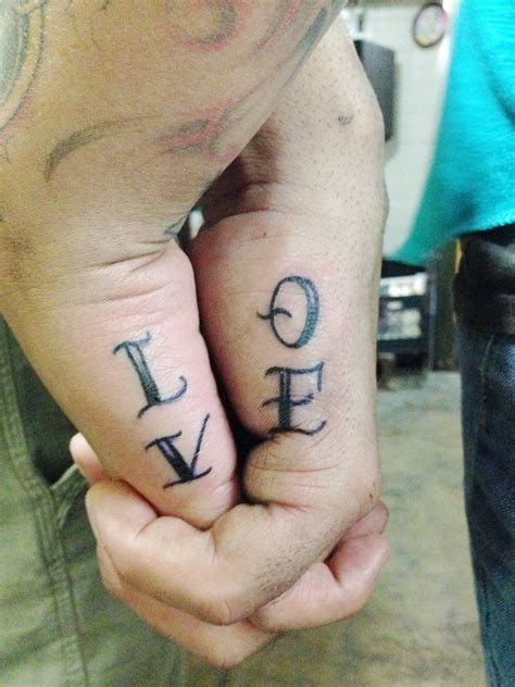couple hand holding love tattoo