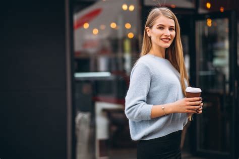 Mujer Con Teléfono Sentado Fuera De Café Foto Gratis