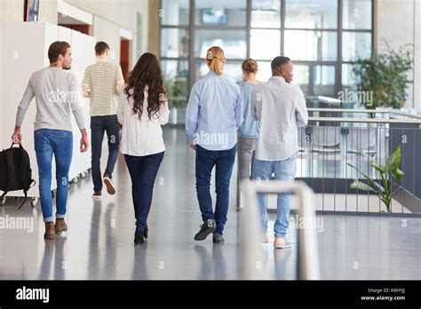 Group Of Students In College Walk In University Hallway Stock Photo Alamy
