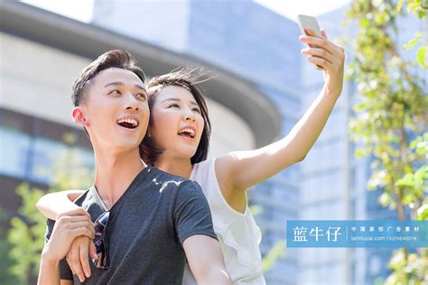 Happy Young Chinese Couple Taking Self Portrait With A Smart Phone High