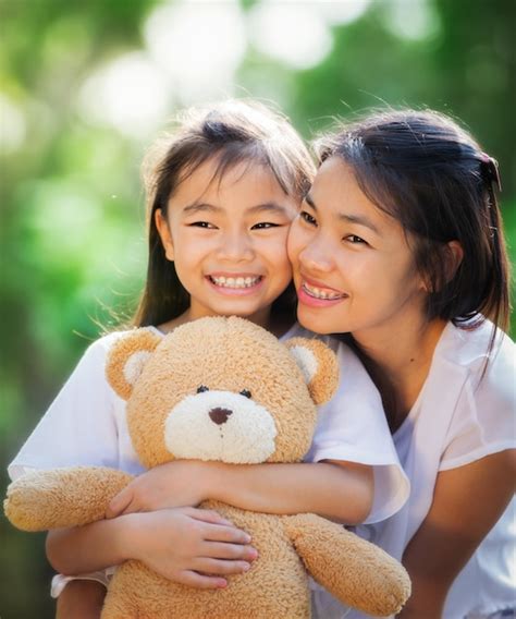 Premium Photo Close Up On Little Asian Girl Hugging A Teddy Bear In