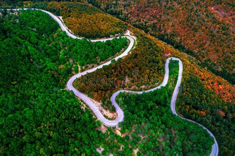 Aerial View Of Drone Over Mountain Road And Curves Going Through Stock